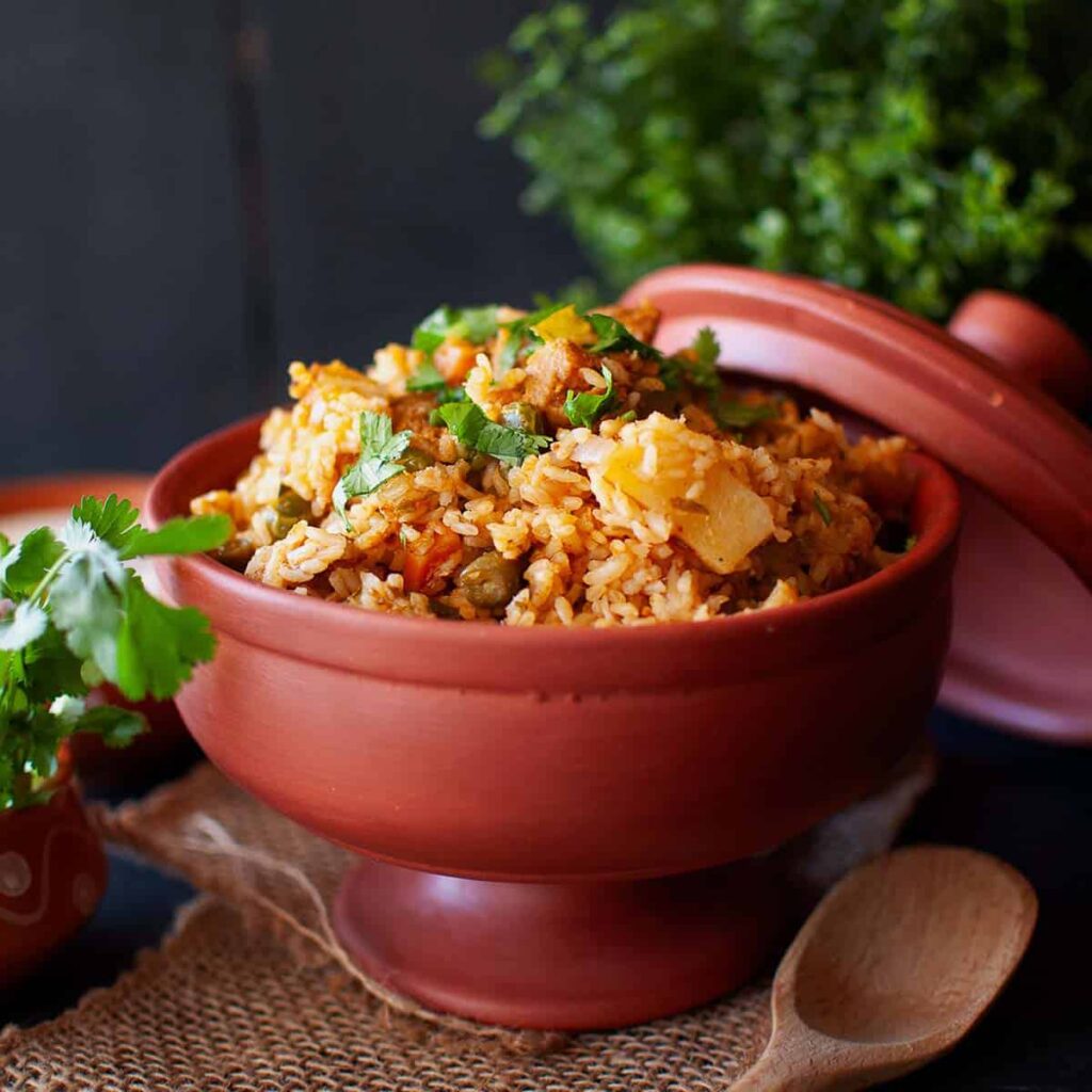 Top view of terracotta bowl with chettinad veg biryani.