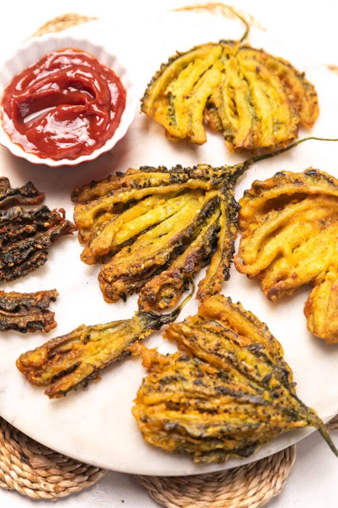 Karela pakoda served on a plate with ketchup