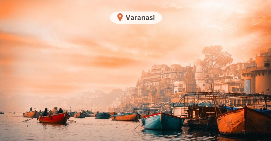 Sunrise view of Varanasi's ghats from a boat on the Ganges River, capturing the serene and spiritual essence of the city.