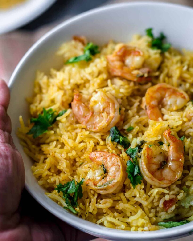 An overhead shot of Shrimp biryani in a white bowl