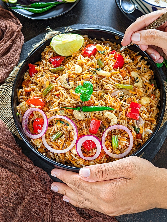 Shahi Veg Biryani garnished with onion rings and lemon