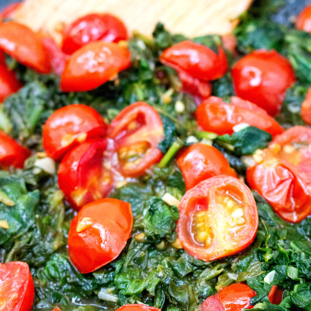 cloase up Garlic Sautéed Spinach and Tomatoes