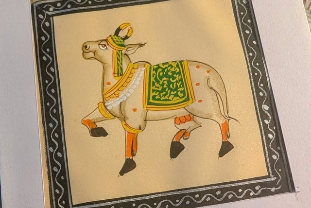 Decorative cow painting - a sacred, recurring motif symbolizing abundance, protection, and divinity