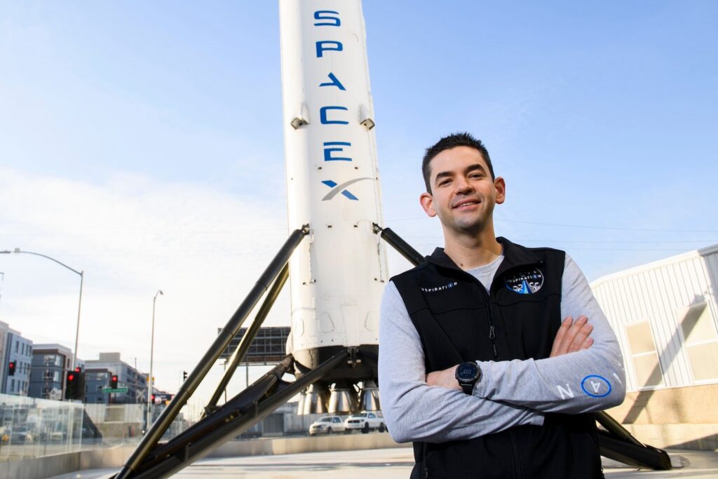 Inspiration4 mission commander Jared Isaacman stands for a portrait in front of the recovered first stage of a Falcon 9 rocket at Space Exploration Technologies Corp. (SpaceX) on February 2, 2021 in Hawthorne, California.