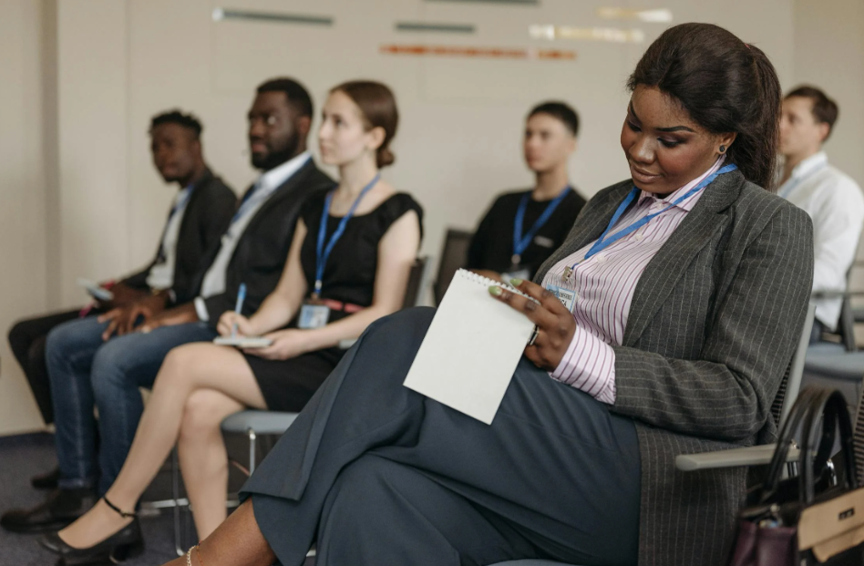 Diverse Group of People Attending a Small Conference