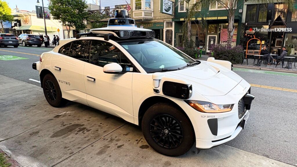 A Waymo Jaguar I-Pace robotaxi waits at the curb in San Francisco. The rooftop lidar dome houses sensors that help the vehicle "see" its surroundings. (Image: Bijin Jose/The Indian Express)