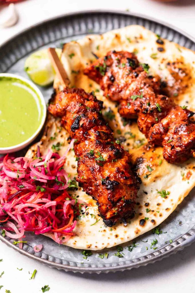 air fryer chicken tikka served on a naan with accompaniments